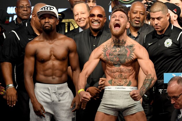 LAS VEGAS, NV - AUGUST 25:  UFC lightweight champion Conor McGregor (R) screams after the face off with Floyd Mayweather Jr. during their official weigh-in at T-Mobile Arena on August 25, 2017 in Las Vegas, Nevada. The two will meet in a super welterweight boxing match at T-Mobile Arena on August 26.  (Photo by Ethan Miller/Getty Images)