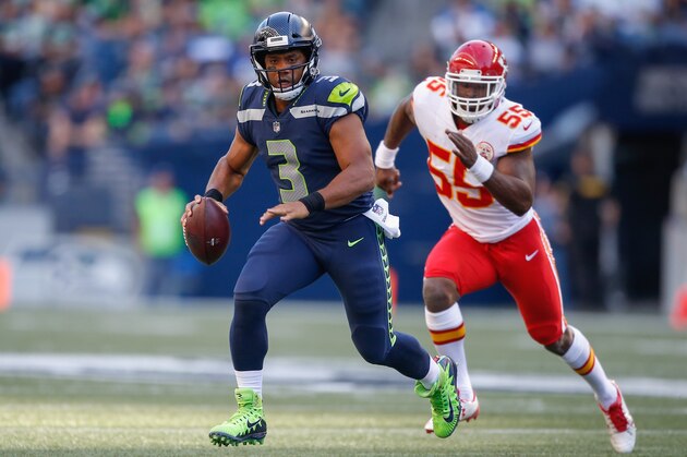 SEATTLE, WA - AUGUST 25:  Quarterback Russell Wilson #3 of the Seattle Seahawks rushes under pressure from linebacker Dee Ford #55 of the Kansas City Chiefs at CenturyLink Field on August 25, 2017 in Seattle, Washington.  (Photo by Otto Greule Jr/Getty Images)