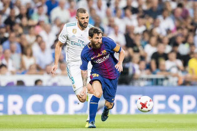 MADRID, SPAIN - AUGUST 16 - Lionel Andres Messi of FC Barcelona fights for the ball with Karim Benzema of Real Madrid during their Supercopa de Espana Final 2nd Leg match between Real Madrid and FC Barcelona at the Estadio Santiago Bernabeu on 16 August 2017 in Madrid, Spain. (Photo by Power Sport Images/Getty Images)
