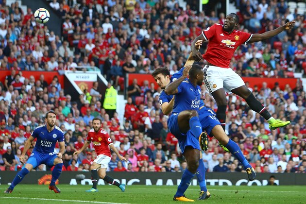 Manchester United's Belgian striker Romelu Lukaku (R) jumps to win a header during the English Premier League football match between Manchester United and Leicester City at Old Trafford in Manchester, north west England, on August 26, 2017. / AFP PHOTO / Geoff CADDICK / RESTRICTED TO EDITORIAL USE. No use with unauthorized audio, video, data, fixture lists, club/league logos or 'live' services. Online in-match use limited to 75 images, no video emulation. No use in betting, games or single club/league/player publications.  /         (Photo credit should read GEOFF CADDICK/AFP/Getty Images)