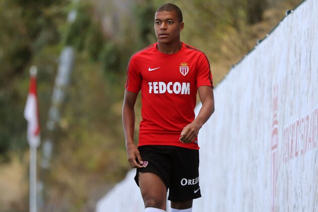 Monaco L1 football club's forward Kylian Mbappe Lottin arrives for a training session on August 11, 2017 in La Turbie, near Monaco.   / AFP PHOTO / VALERY HACHE        (Photo credit should read VALERY HACHE/AFP/Getty Images)