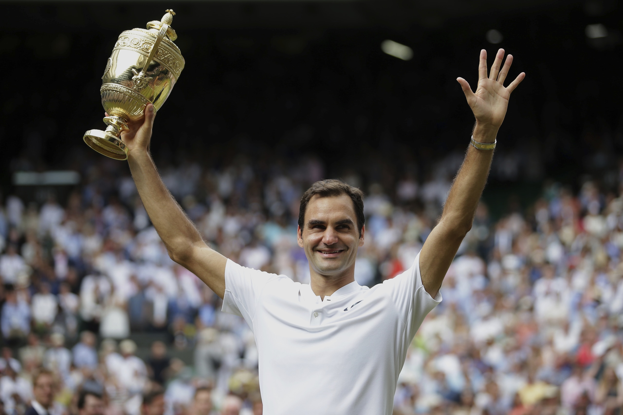 Switzerland's Roger Federer celebrates with the trophy after beating Croatia's Marin Cilic in the Men's Singles final match on day thirteen at the Wimbledon Tennis Championships in London Sunday, July 16, 2017. (Daniel Leal-Olivas/Pool Photo via AP)