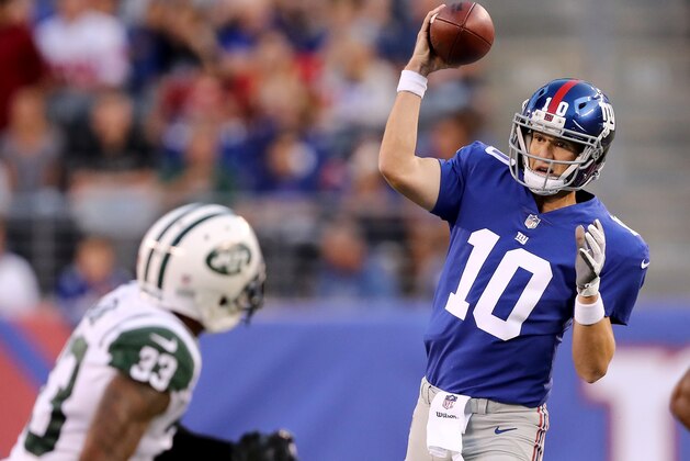 EAST RUTHERFORD, NJ - AUGUST 26:   Eli Manning #10 of the New York Giants looks to pass as  Jamal Adams #33 of the New York Jets defends in the first quarter during a preseason game on August 26, 2017 at MetLife Stadium in East Rutherford, New Jersey  (Photo by Elsa/Getty Images)
