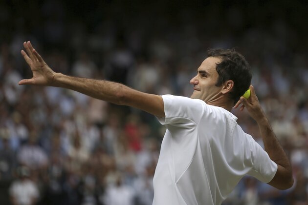 Switzerland's Roger Federer throws a ball into the crowd after defeating Croatia's Marin Cilic in the Men's Singles final match on day thirteen at the Wimbledon Tennis Championships in London Sunday, July 16, 2017. (Daniel Leal-Olivas/Pool Photo via AP)