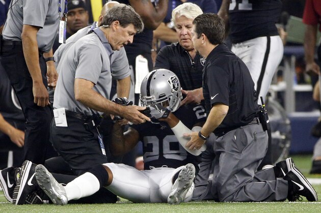 Oakland Raiders cornerback David Amerson (29) is checked on by team medical staff after suffering an unknown injury in the first half of a preseason NFL football game against the Dallas Cowboys on Saturday, Aug. 26, 2017, in Arlington, Texas. (AP Photo/Ron Jenkins)