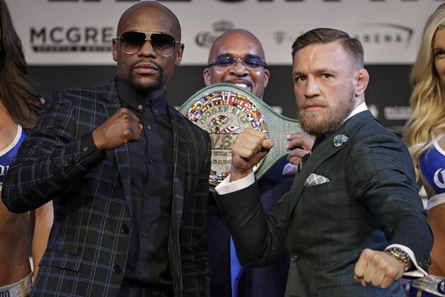 Floyd Mayweather Jr., left, and Conor McGregor pose for photographers during a news conference Wednesday, Aug. 23, 2017, in Las Vegas. The two are scheduled to fight in a boxing match Saturday in Las Vegas. (AP Photo/John Locher)