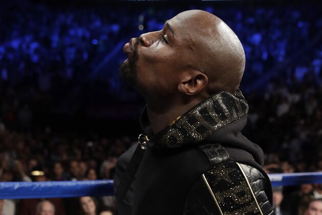 Floyd Mayweather Jr. enters the ring before a super welterweight boxing match against Conor McGregor, Saturday, Aug. 26, 2017, in Las Vegas. (AP Photo/Isaac Brekken)