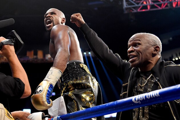 LAS VEGAS, NV - AUGUST 26:  (L-R) Floyd Mayweather Jr. and  Floyd Mayweather Sr. celebrate after defeating Conor McGregor during their super welterweight boxing match on August 26, 2017 at T-Mobile Arena in Las Vegas, Nevada.  (Photo by Josh Hedges/Zuffa LLC/Zuffa LLC via Getty Images )