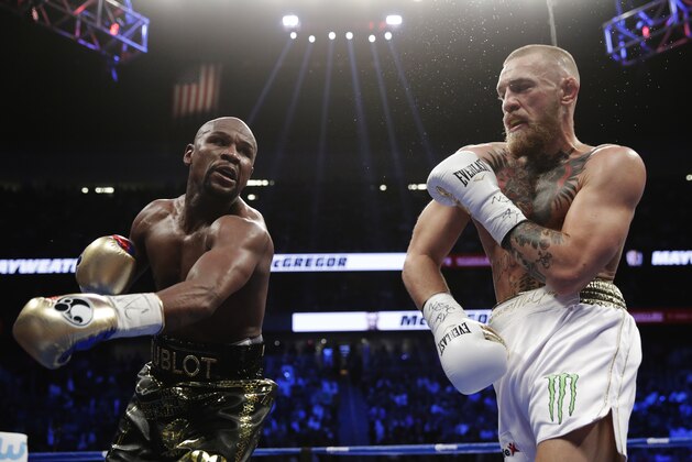 Floyd Mayweather Jr., left, swings at Conor McGregor in a super welterweight boxing match Saturday, Aug. 26, 2017, in Las Vegas. (AP Photo/Isaac Brekken) Floyd Mayweather Jr., left, swings at Conor McGregor in a super welterweight boxing match Saturday, Aug. 26, 2017, in Las Vegas. (AP Photo/Isaac Brekken)