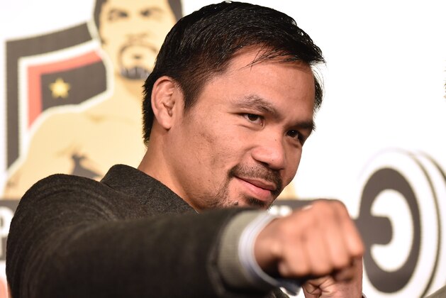WBO welterweight world champion Manny Pacquiao poses for the media following a press conference at his boxing gym in Tokyo on November 25, 2016.
WBO welterweight world champion Manny Pacquiao on November 25 kept alive hopes for a rematch with Floyd Mayweather, saying the epic clash was 'possible' but only if his arch rival returns to the ring. / AFP / KAZUHIRO NOGI        (Photo credit should read KAZUHIRO NOGI/AFP/Getty Images)