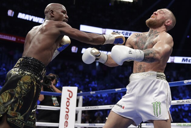 Floyd Mayweather Jr. hits Conor McGregor in a super welterweight boxing match Saturday, Aug. 26, 2017, in Las Vegas. (AP Photo/Isaac Brekken) Floyd Mayweather Jr. hits Conor McGregor in a super welterweight boxing match Saturday, Aug. 26, 2017, in Las Vegas. (AP Photo/Isaac Brekken)