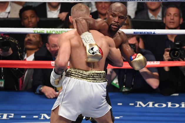 LAS VEGAS, NV - AUGUST 26:  (R-L) Floyd Mayweather Jr. holds Conor McGregor during their super welterweight boxing match on August 26, 2017 at T-Mobile Arena in Las Vegas, Nevada.  (Photo by Ethan Miller/Getty Images)