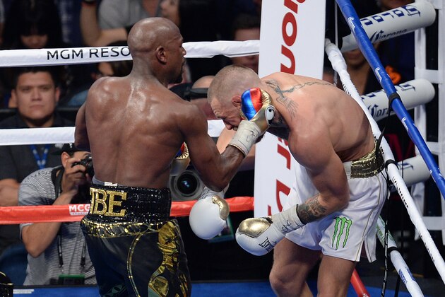 Aug 26, 2017; Las Vegas, NV, USA; Floyd Mayweather Jr. (black trunks) and Conor McGregor (white trunks) box during the tenth round of their boxing match at T-Mobile Arena. Mayweather won via tenth round TKO. Mandatory Credit: Joe Camporeale-USA TODAY Sports