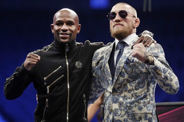 Floyd Mayweather Jr., left, and Conor McGregor pose during a news conference after a super welterweight boxing match Sunday, Aug. 27, 2017, in Las Vegas. (AP Photo/Isaac Brekken)