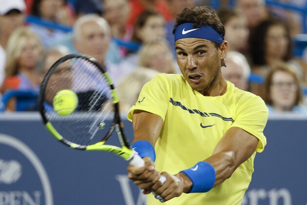 File-This Aug. 18, 2017, file photo shows Rafael Nadal, of Spain, returning to Nick Kyrgios, of Australia, at the Western & Southern Open tennis tournament in Mason, Ohio. (AP Photo/John Minchillo, File)