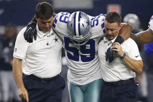 Dallas Cowboys team medical staff assist linebacker Anthony Hitchens (59) after Hitchens suffered an unknown injury in the first half of a preseason NFL football game against the Oakland Raiders on Saturday, Aug. 26, 2017, in Arlington, Texas. (AP Photo/Ron Jenkins)