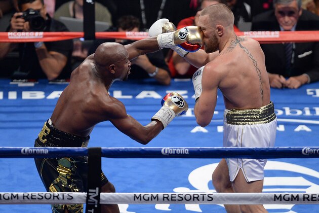 Aug 26, 2017; Las Vegas, NV, USA; Floyd Mayweather Jr. (black trunks) and Conor McGregor (white trunks) box during their boxing match at T-Mobile Arena. Mayweather won via tenth round TKO. Mandatory Credit: Joe Camporeale-USA TODAY Sports Aug 26, 2017; Las Vegas, NV, USA; Floyd Mayweather Jr. (black trunks) and Conor McGregor (white trunks) box during their boxing match at T-Mobile Arena. Mayweather won via tenth round TKO. Mandatory Credit: Joe Camporeale-USA TODAY Sports