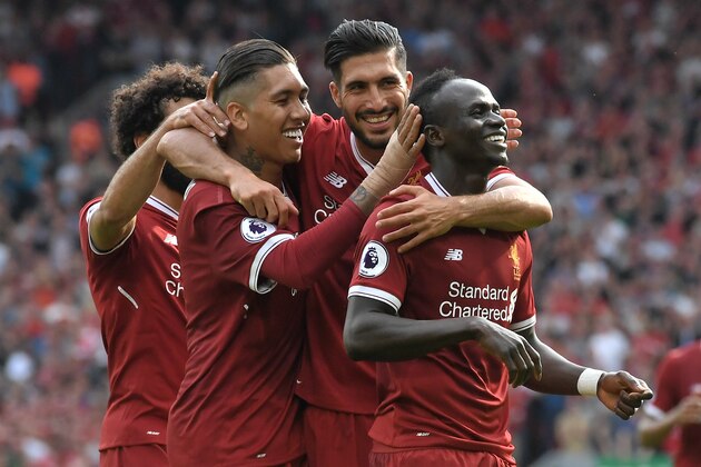 Liverpool's Senegalese midfielder Sadio Mane (R) celebrates with teammates after scoring their second goal during the English Premier League football match between Liverpool and Arsenal at Anfield in Liverpool, north west England on August 27, 2017. / AFP PHOTO / Anthony Devlin / RESTRICTED TO EDITORIAL USE. No use with unauthorized audio, video, data, fixture lists, club/league logos or 'live' services. Online in-match use limited to 75 images, no video emulation. No use in betting, games or single club/league/player publications.  /         (Photo credit should read ANTHONY DEVLIN/AFP/Getty Images)