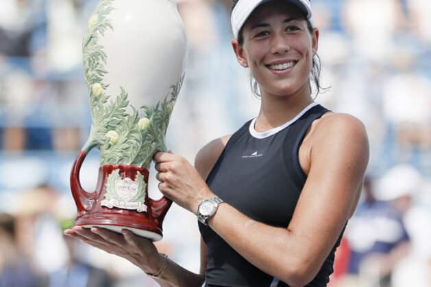 Garbine Muguruza, of Spain, holds the Rookwood Cup after defeating Simona Halep, of Romania, in the women's singles final at the Western & Southern Open, Sunday, Aug. 20, 2017, in Mason, Ohio. Muguruza won 6-1, 6-0. (AP Photo/John Minchillo)