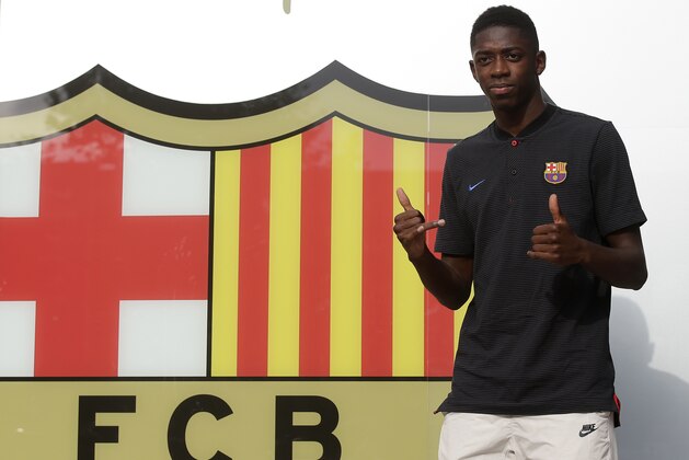 French soccer player Ousmane Dembele gestures during his arrival at the club's office at the Camp Nou stadium in Barcelona, Spain, Sunday, Aug. 27, 2017. Barcelona is shoring up its attack following Neymar's departure by buying Ousmane Dembele from Borussia Dortmund in a deal that could reach 147 million euros (about $173 million), second only to the Brazilian star's world-record transfer. (AP Photo/Manu Fernandez)