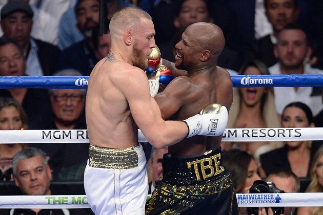 Aug 26, 2017; Las Vegas, NV, USA; Floyd Mayweather Jr. (black trunks) taunts Conor McGregor (white trunks) during their boxing match at T-Mobile Arena. Mayweather won via tenth round TKO. Mandatory Credit: Joe Camporeale-USA TODAY Sports