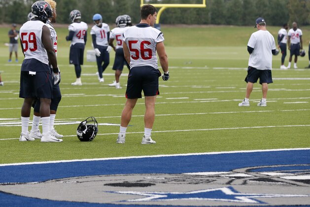 Houston Texans' Whitney Mercilus (59) and Brian Cushing (56) stand on the field as they wait to participate in drills during a morning practice at the Dallas Cowboys training facility, Monday, Aug. 28, 2017, in Frisco, Texas. The Texans are working out in the practice facility of the Cowboys because of floods pounding Houston. An exhibition game in the Texans' stadium Thursday might be moved to the home of the Cowboys. (AP Photo/Tony Gutierrez)