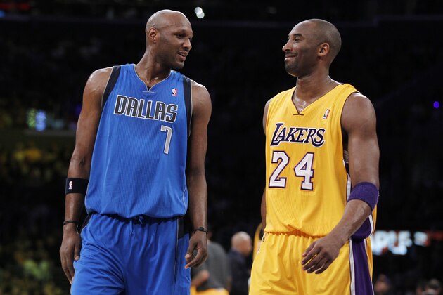 Dallas Mavericks' Lamar Odom, left, interacts with Los Angeles Lakers' Kobe Bryant, right, as they come back to the court after a time out in the first quarter of an NBA basketball game in Los Angeles on Monday, Jan. 16, 2012. (AP Photo/Danny Moloshok)