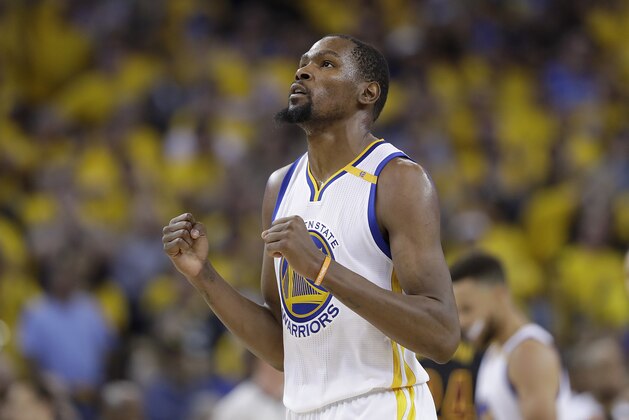 FILE - In this June 12, 2017 file photo, Golden State Warriors forward Kevin Durant reacts after scoring against the Cleveland Cavaliers during the second half of Game 5 of basketball's NBA Finals in Oakland, Calif. A person with knowledge of the situation tells The Associated Press that Durant has agreed to terms on a two-year deal worth about $53 million to remain with the Golden State Warriors. The deal calls for about $25 million in the first year with a player option for the second season. The person spoke on condition of anonymity because the contract cannot be signed until Thursday, July 6, 2017. (AP Photo/Marcio Jose Sanchez, File)
