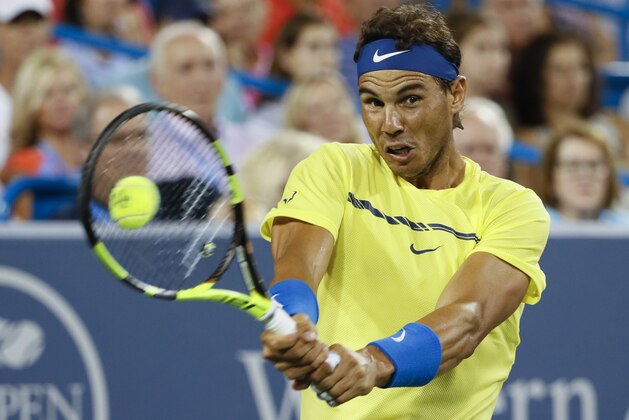 File-This Aug. 18, 2017, file photo shows Rafael Nadal, of Spain, returning to Nick Kyrgios, of Australia, at the Western & Southern Open tennis tournament in Mason, Ohio. (AP Photo/John Minchillo, File)