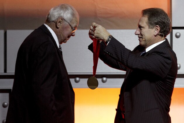 Former Michigan State basketball coach Jud Heathcote, left, is presented with a medal by current Michigan State coach Tom Izzo as Heathcote is inducted into the National Collegiate Basketball Hall of Fame, Sunday, Nov. 22, 2009, in Kansas City, Mo.  Other inductees include Larry Bird, Earvin