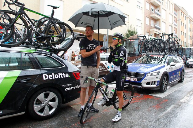 Team Dimension Data members take refuge from the rain rides before the 10th stage of the 72nd edition of 'La Vuelta' Tour of Spain cycling race, a 164,8 km route between Caravaca to Alhama de Murcia, on August 29, 2017. / AFP PHOTO / JOSE JORDAN        (Photo credit should read JOSE JORDAN/AFP/Getty Images)