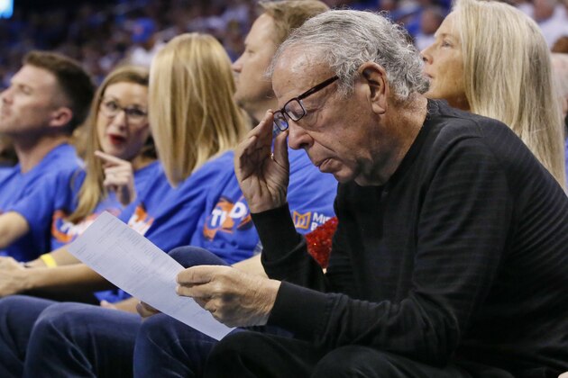 Leslie Alexander, owner of the Houston Rockets, looks over a stat sheet during the third quarter of the team's first-round NBA basketball playoff game against the Oklahoma City Thunder in Oklahoma City, Friday, April 21, 2017. Oklahoma City won 115-113. (AP Photo/Sue Ogrocki)