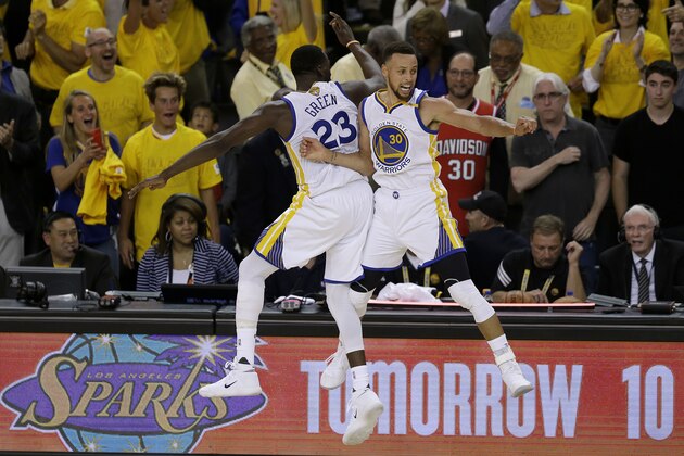 Golden State Warriors forward Draymond Green, left, and guard Stephen Curry (30) celebrate during the second half of Game 5 of basketball's NBA Finals against the Cleveland Cavaliers in Oakland, Calif., Monday, June 12, 2017. The Warriors won 129-120 to win the NBA championship. (AP Photo/Ben Margot)