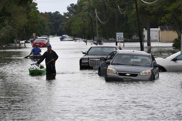 Local residents wade through flooded streets after Hurricane Harvey caused heavy flooding in Crosby, Texas on August 30, 2017.  
Monster storm Harvey made landfall again Wednesday in Louisiana, evoking painful memories of Hurricane Katrina's deadly strike 12 years ago, as time was running out in Texas to find survivors in the raging floodwaters. / AFP PHOTO / MARK RALSTON        (Photo credit should read MARK RALSTON/AFP/Getty Images)