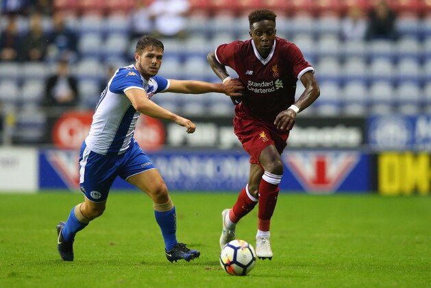 WIGAN, ENGLAND - JULY 14:  Divock Origi of Liverpool beats Luke Burke of Wigan Athletic during the pre-season friendly match between Wigan Athletic and Liverpool at DW Stadium on July 14, 2017 in Wigan, England.  (Photo by Alex Livesey/Getty Images)
