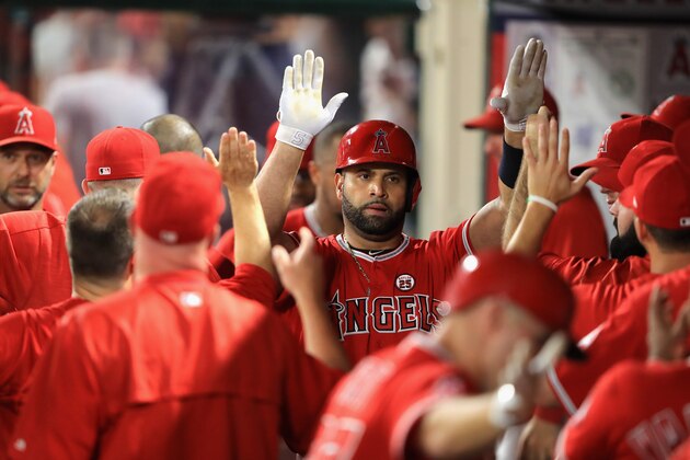 ANAHEIM, CA - AUGUST 30:  Albert Pujols #5 of the Los Angeles Angels is congratulated in the dugout after hitting a two-run homerun during the fifth  inning of a game against the Oakland Athletics  at Angel Stadium of Anaheim on August 30, 2017 in Anaheim, California.  (Photo by Sean M. Haffey/Getty Images)
