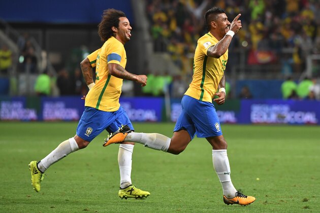 Brazil's Paulinho (R) celebrates with teammate Marcelo after scoring against Ecuador during their 2018 World Cup football qualifier match in Porto Alegre, Brazil, on August 31, 2017. / AFP PHOTO / Nelson ALMEIDA        (Photo credit should read NELSON ALMEIDA/AFP/Getty Images)