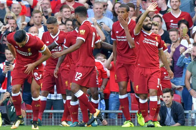 Liverpool's Egyptian midfielder Mohamed Salah (R) celebrates with teammates after scoring their third goal during the English Premier League football match between Liverpool and Arsenal at Anfield in Liverpool, north west England on August 27, 2017. / AFP PHOTO / Anthony Devlin / RESTRICTED TO EDITORIAL USE. No use with unauthorized audio, video, data, fixture lists, club/league logos or 'live' services. Online in-match use limited to 75 images, no video emulation. No use in betting, games or single club/league/player publications.  /         (Photo credit should read ANTHONY DEVLIN/AFP/Getty Images)