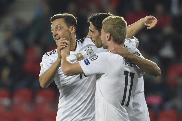 Germany's forward Timo Werner (R) celebrates with Germany's midfielder Mesut Ozil (L) and Germany's forward Lars Stindl scoring the opening goal during the FIFA World Cup 2018 qualification football match between Czech Republic and Germany in Plzen, Czech Republic on September 1, 2017. / AFP PHOTO / Michal Cizek        (Photo credit should read MICHAL CIZEK/AFP/Getty Images)