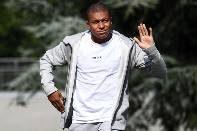France's forward Kylian Mbappe waves as he arrives at the French national football team training base in Clairefontaine on August 28, 2017,  as part of the team's preparation for the FIFA World Cup 2018 qualifying football match against Netherlands and Luxembourg. 
Monaco's teen sensation Kylian Mbappe is expected to complete a stunning move to Paris Saint-Germain when he flies into the French capital on August 28, according to widespread French media reports. Radio stations France Info and RMC revealed on Sunday that PSG had agreed to pay 180 million euros ($215 million) including bonuses for the 18-year-old French international striker. / AFP PHOTO / FRANCK FIFE        (Photo credit should read FRANCK FIFE/AFP/Getty Images)