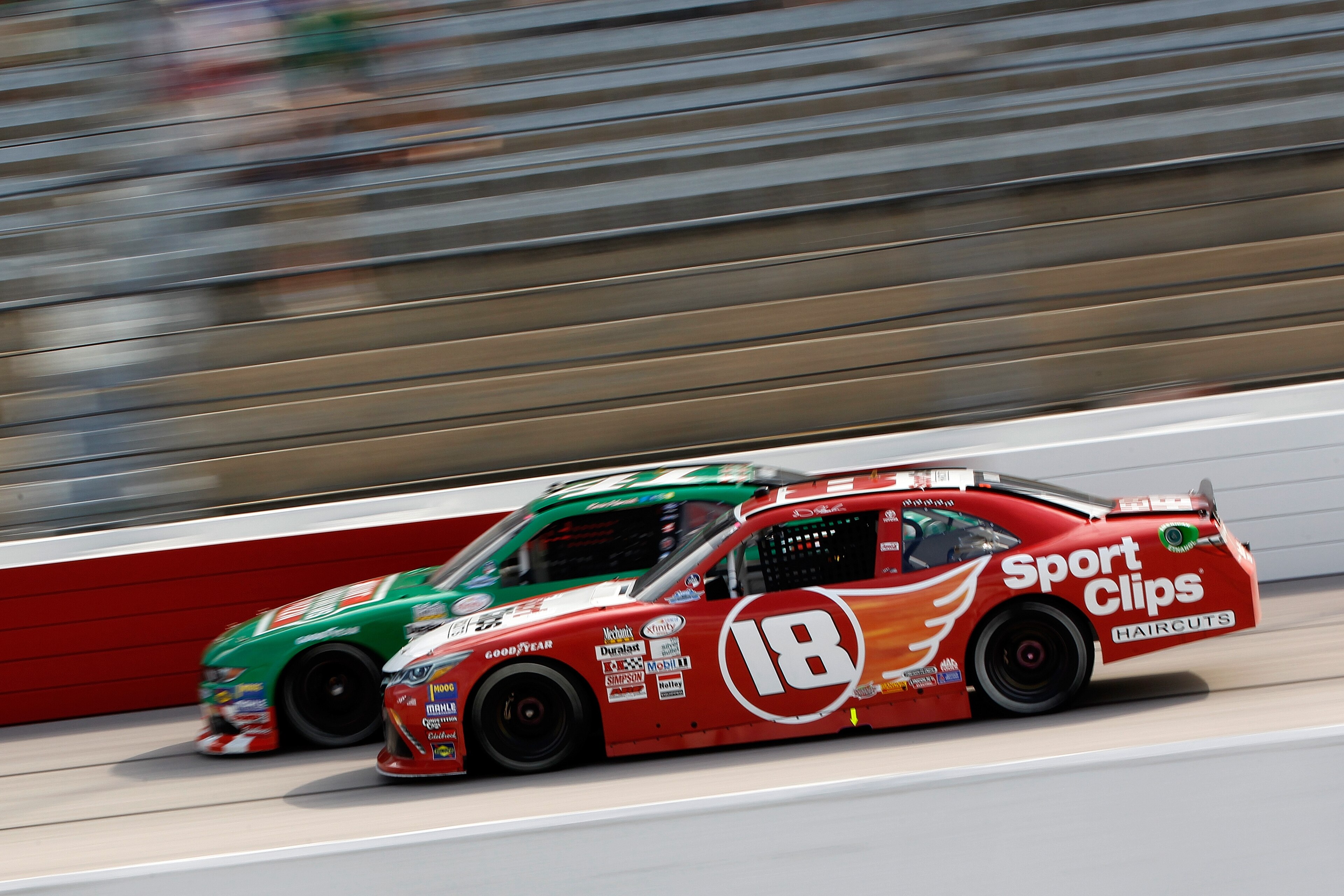DARLINGTON, SC - SEPTEMBER 02:  Denny Hamlin, driver of the #18 Sport Clips Toyota, races Kevin Harvick, driver of the #41 Hunt Brothers Pizza Throwback Ford, during the NASCAR XFINITY Series Sports Clips Haircuts VFW 200 at Darlington Raceway on September 2, 2017 in Darlington, South Carolina.  (Photo by Brian Lawdermilk/Getty Images)