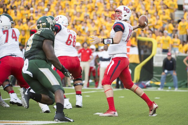 WACO, TX - SEPTEMBER 2:  Stephen Calvert #12 of the Liberty Flames drops back to pass against the Baylor Bears during the first half at McLane Stadium on September 2, 2017 in Waco, Texas.  (Photo by Cooper Neill/Getty Images)