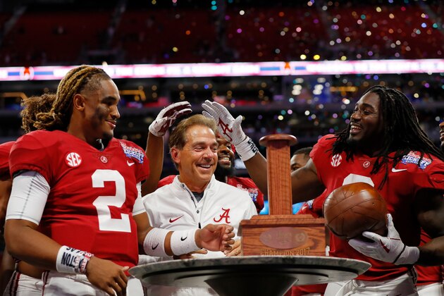 ATLANTA, GA - SEPTEMBER 02:  Bo Scarbrough #9, head coach Nick Saban, and Jalen Hurts #2 of the Alabama Crimson Tide celebrate with the Chick-fil-A Kick-Off Game trophy after defeating the Florida State Seminoles 24-7 in their game at Mercedes-Benz Stadium on September 2, 2017 in Atlanta, Georgia.  (Photo by Kevin C. Cox/Getty Images)