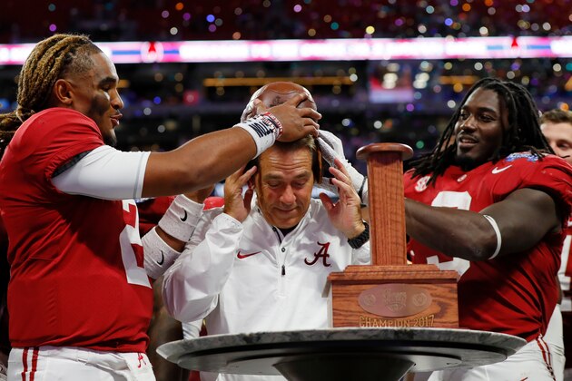 ATLANTA, GA - SEPTEMBER 02:  Bo Scarbrough #9, head coach Nick Saban, and Jalen Hurts #2 of the Alabama Crimson Tide celebrate with the Chick-fil-A Kick-Off Game trophy after defeating the Florida State Seminoles 24-7 in their game at Mercedes-Benz Stadium on September 2, 2017 in Atlanta, Georgia.  (Photo by Kevin C. Cox/Getty Images)
