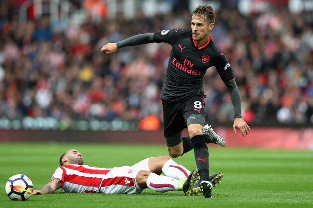 STOKE ON TRENT, ENGLAND - AUGUST 19: Jese of Stoke City attempts to tackle Aaron Ramsey of Arsenal during the Premier League match between Stoke City and Arsenal at Bet365 Stadium on August 19, 2017 in Stoke on Trent, England.  (Photo by David Rogers/Getty Images)