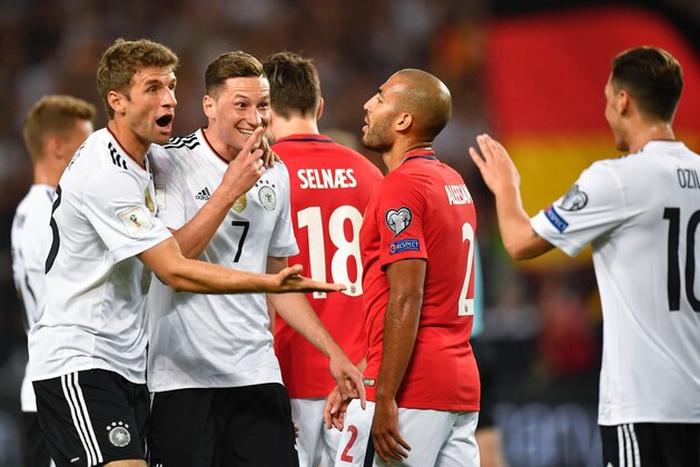 Germany's midfielder Julian Draxler (2nd,L) celebrates scoring his side's second goal during the FIFA World Cup 2018 qualification match between Germany and Norway in the south German city of Stuttgart on September 4, 2017. / AFP PHOTO / THOMAS KIENZLE        (Photo credit should read THOMAS KIENZLE/AFP/Getty Images)