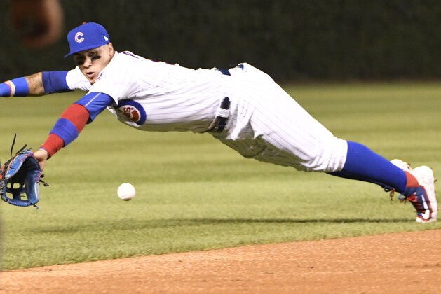 CHICAGO, IL - AUGUST 28: Javier Baez #9 of the Chicago Cubs makes a diving play on a ball off the bat of Jose Osuna of the Pittsburgh Pirates during the third inning on August 28, 2017 at Wrigley Field in Chicago, Illinois. (Photo by David Banks/Getty Images)