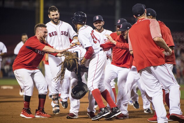 BOSTON, MA - SEPTEMBER 5: Hanley Ramirez #13 of the Boston Red Sox is mobbed by Mookie Betts #50 and teammates during the nineteenth inning of a game against the Toronto Blue Jays on September 5, 2017 at Fenway Park in Boston, Massachusetts. (Photo by Billie Weiss/Boston Red Sox/Getty Images)