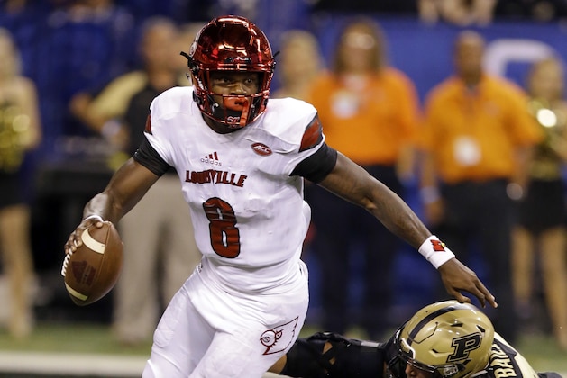 Louisville quarterback Lamar Jackson (8) gets away from Purdue linebacker Markus Bailey (21) during the first half of an NCAA college football game in Indianapolis, Saturday, Sept. 2, 2017. (AP Photo/Michael Conroy)