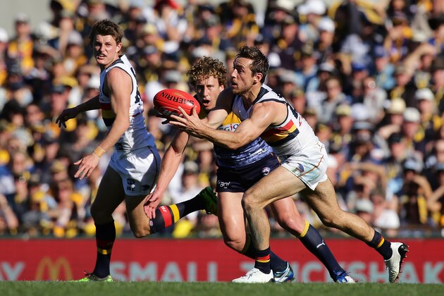 PERTH, VICTORIA - AUGUST 27: Richard Douglas of the Crows marks the ball  under pressure from Matt Priddis of the Eagles during the round 23 AFL match between the West Coast Eagles and the Adelaide Crows at Domain Stadium on August 27, 2017 in Perth, Australia.  (Photo by Will Russell/AFL Media/Getty Images)